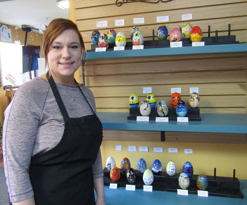 Aysha Diril, co-owner of Go Paint!, shows off the eggs decorated by amateur artists. The public can vote through March 31 for their favorite eggs, with the winners receiving prizes.